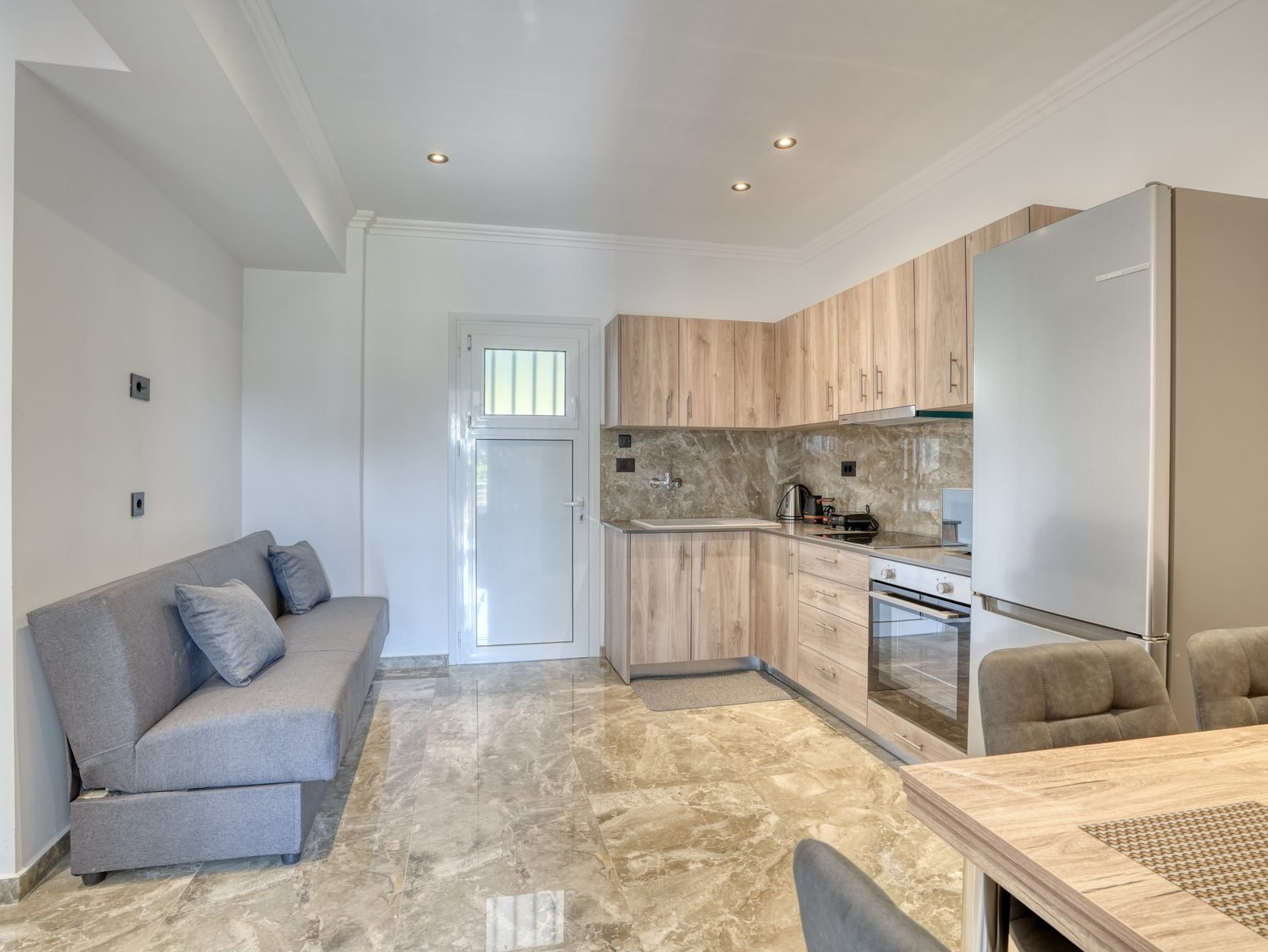 Open-plan living area and kitchen in a renovated apartment at Bill & Mike, Kefalos