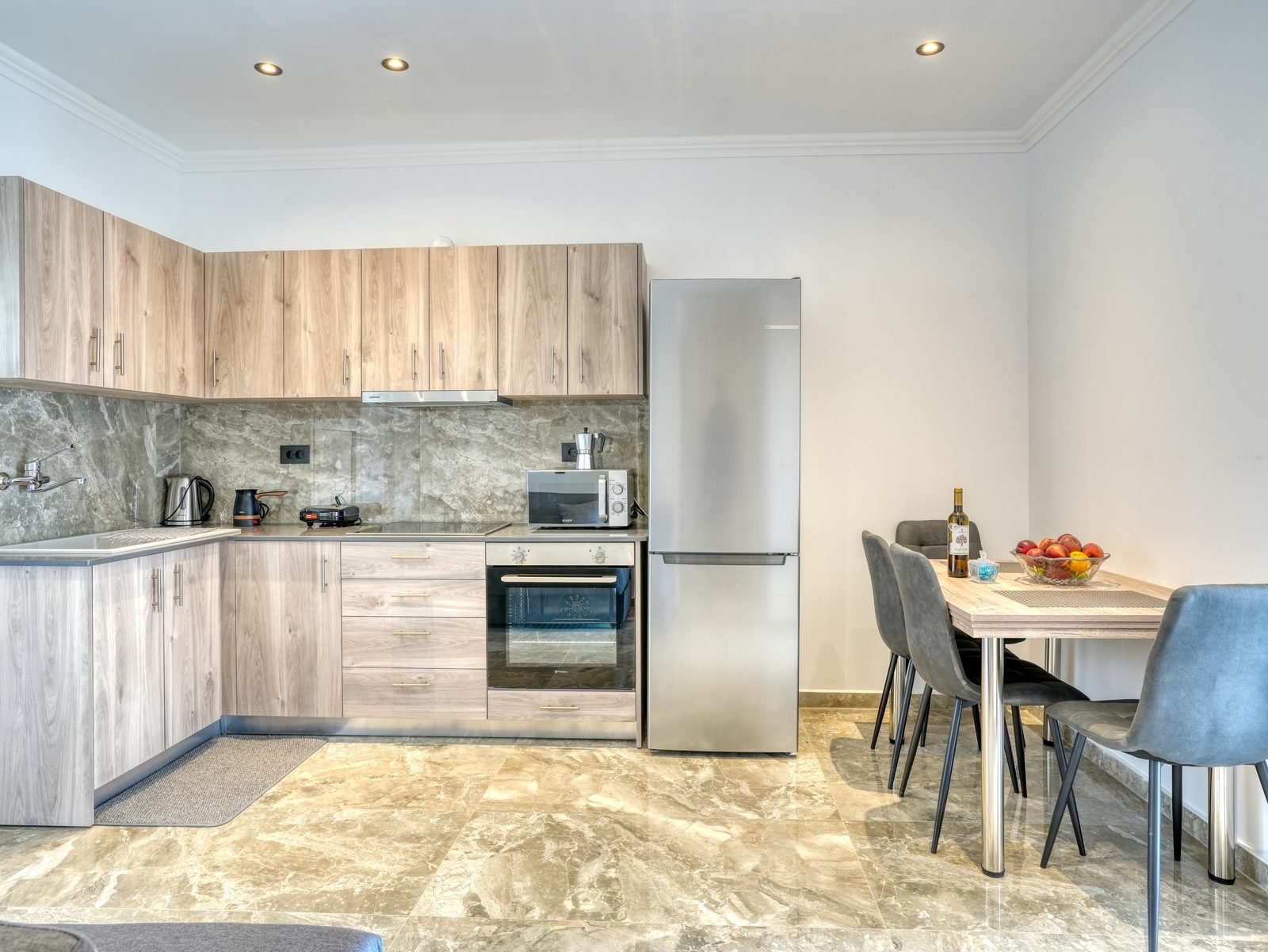 Full-size kitchen with oven, fridge and dining table for four