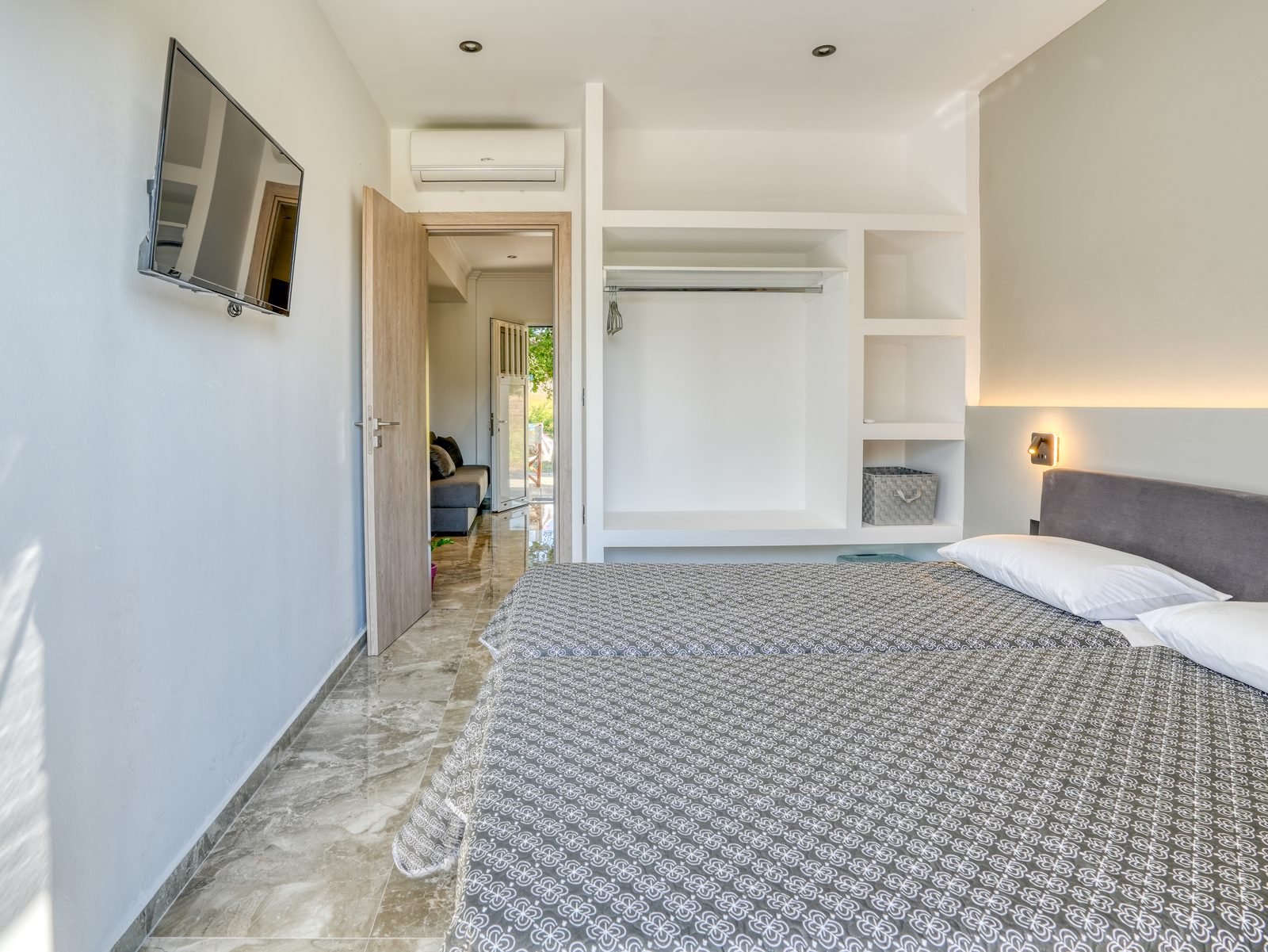 Bedroom with fitted wardrobe opening through to the living area