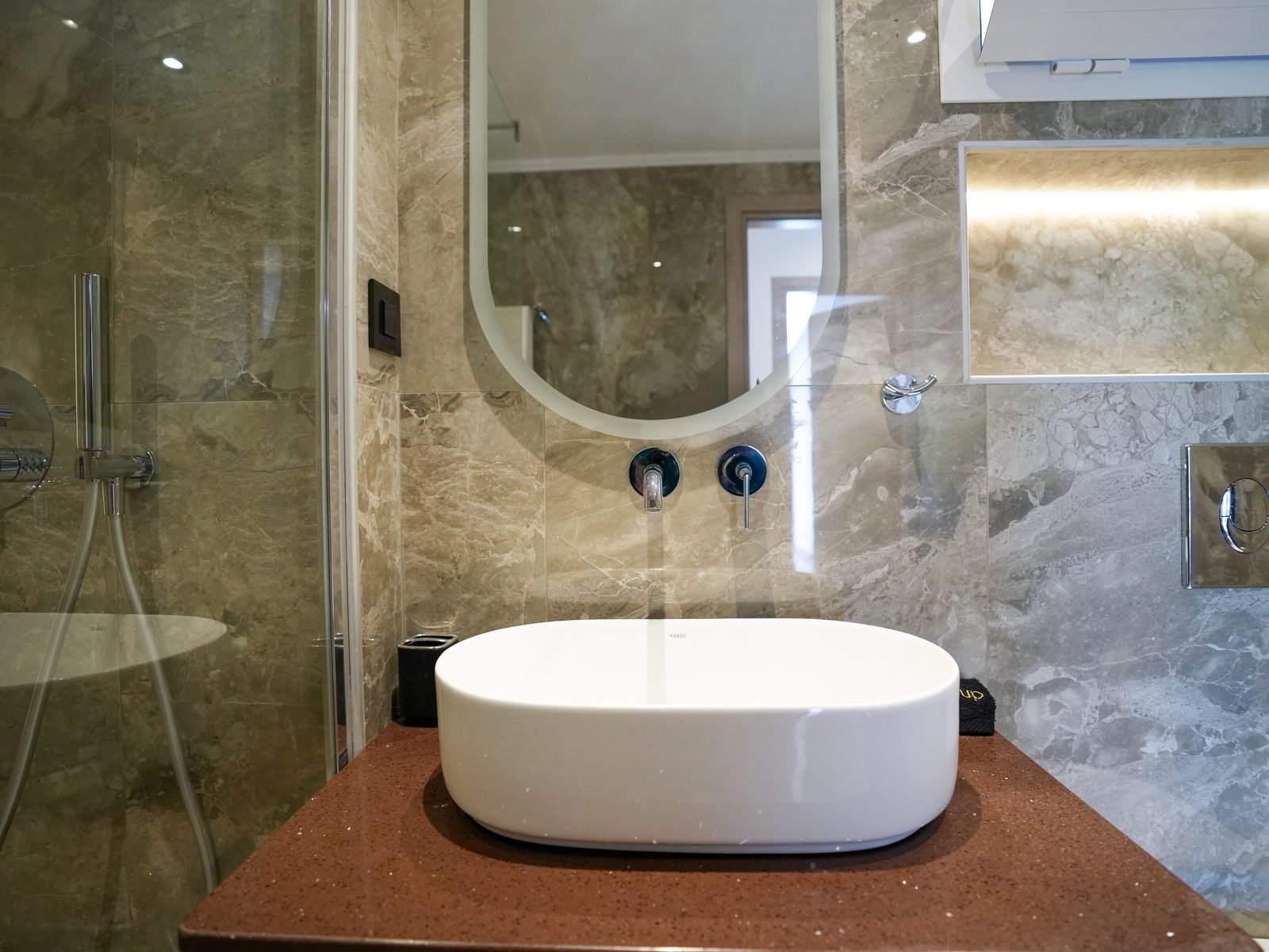 Bathroom vanity with vessel basin and backlit mirror
