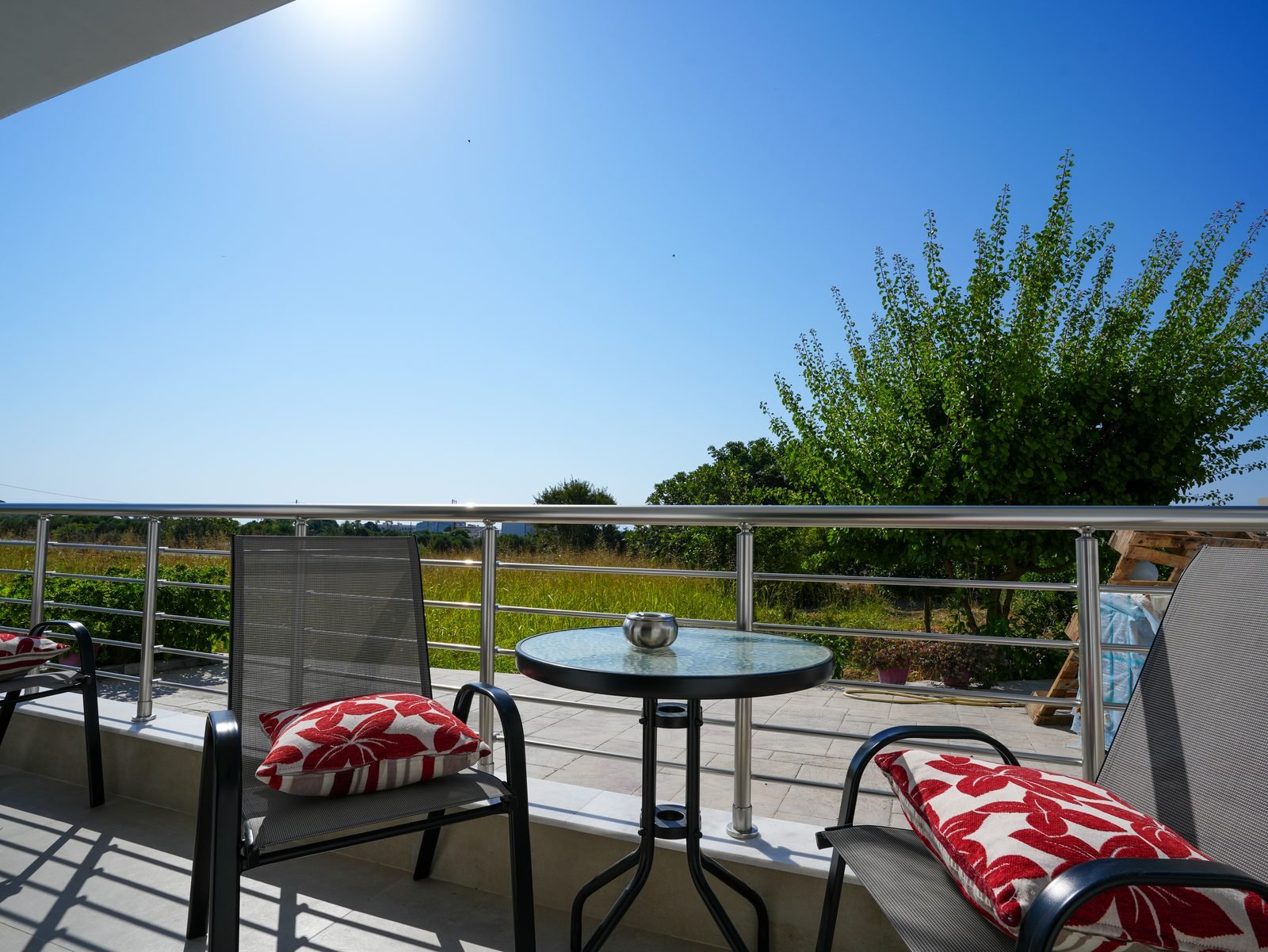 Private balcony with table and chairs looking over the garden
