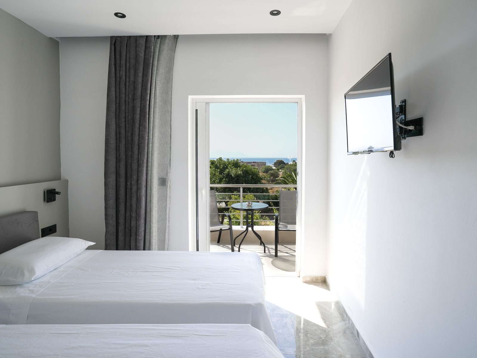 Sea View Apartment — bedroom with balcony over the bay